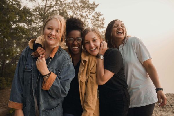 Friends laughing together outside.
