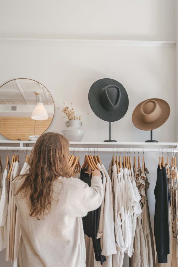 Person shopping at clothes boutique.